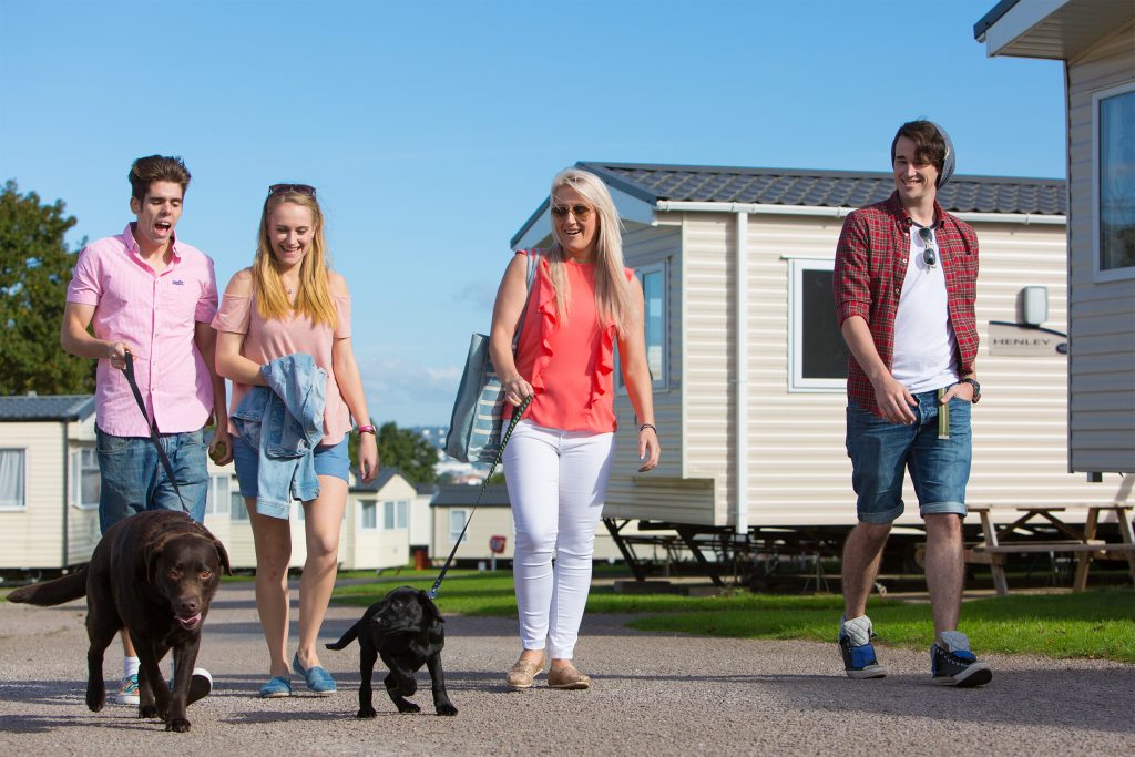 Group walking with dog around holiday parks