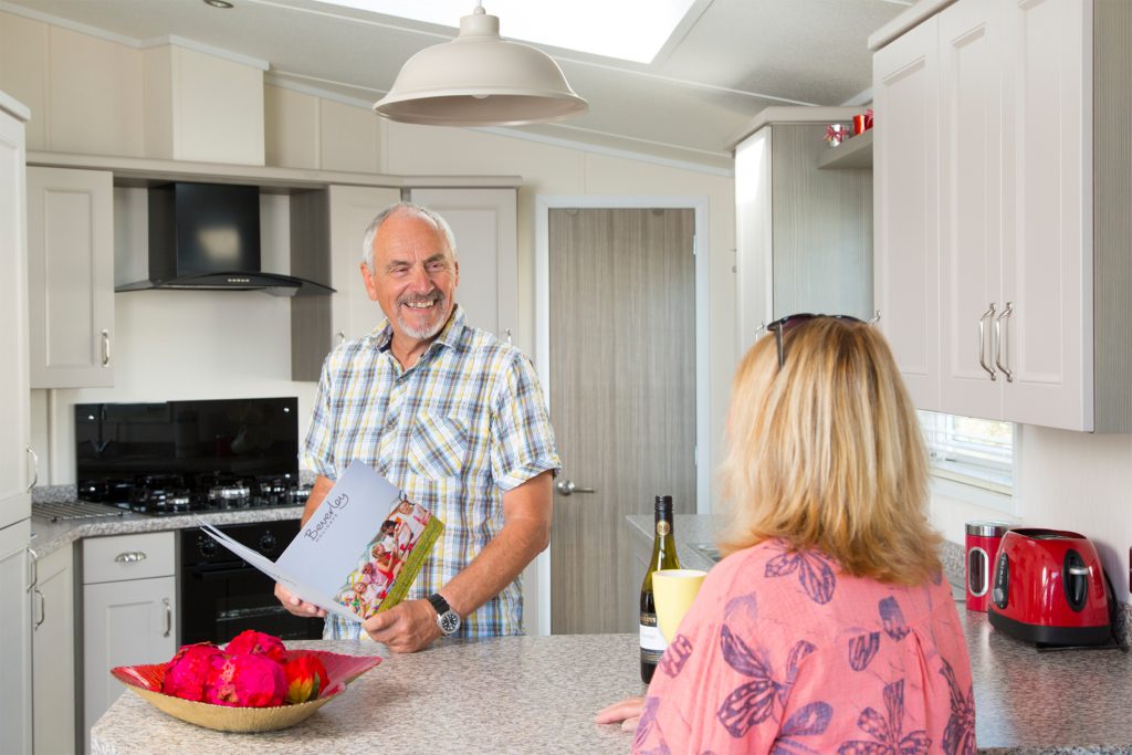 Couple in a kitchen. Holiday homes in Devon