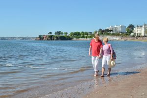 Walking on the beach in Torquay on the English Riviera. UK Holiday Breaks