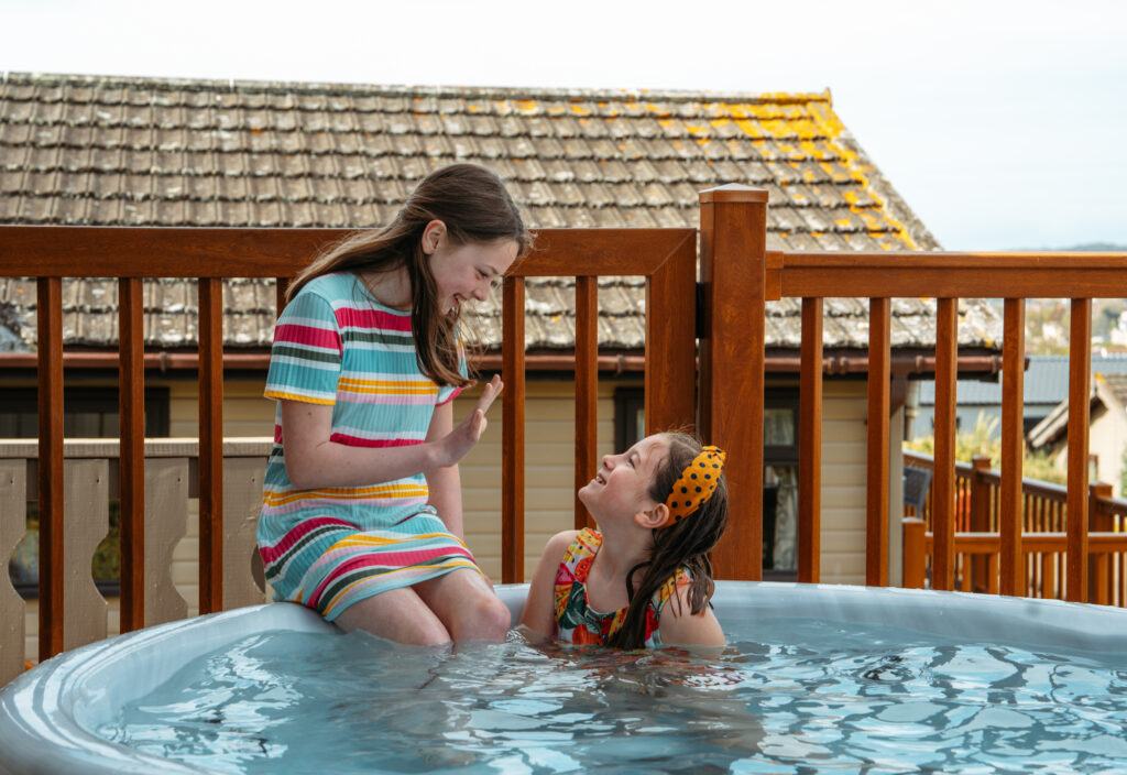 Family Friendly hot tub with two girls playing in the water at  Beverley Holidays