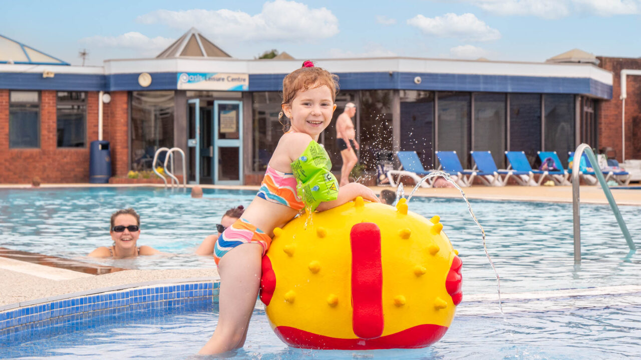 little girl in outdoor pool