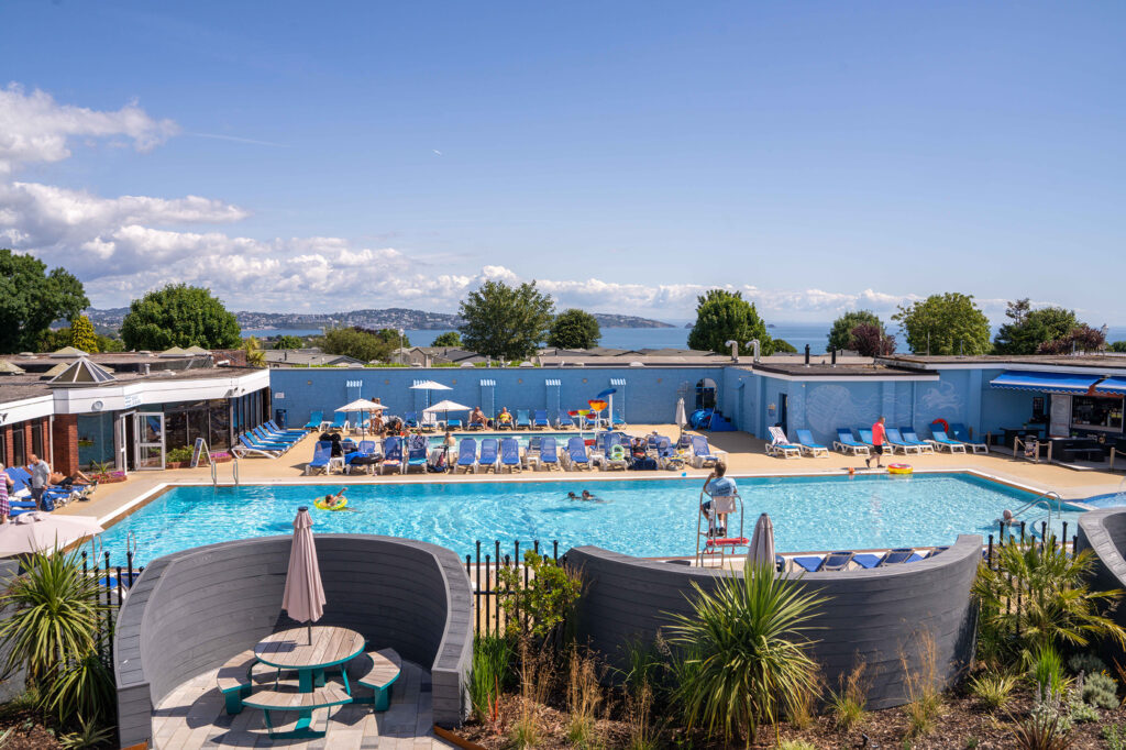 outdoor pool with view of sea in background