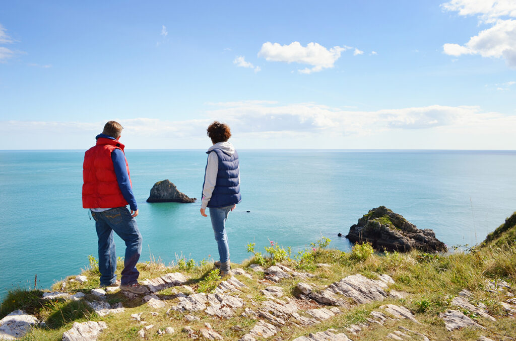 Walks around brixham - 2 people looking out at the view from Berry head