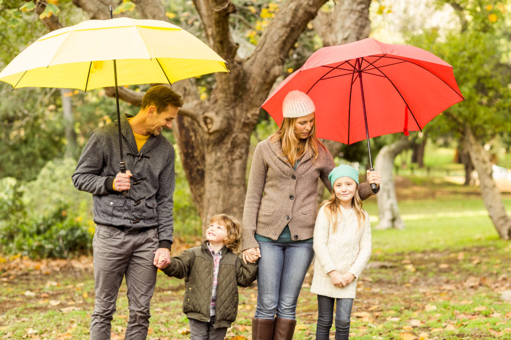 family using umbrellas. rainy day activities devon