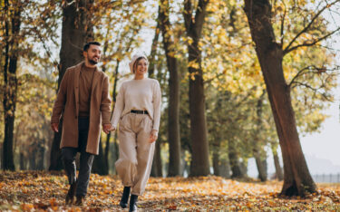 Couple walking in Autumn woods. Autumn Weekend Break