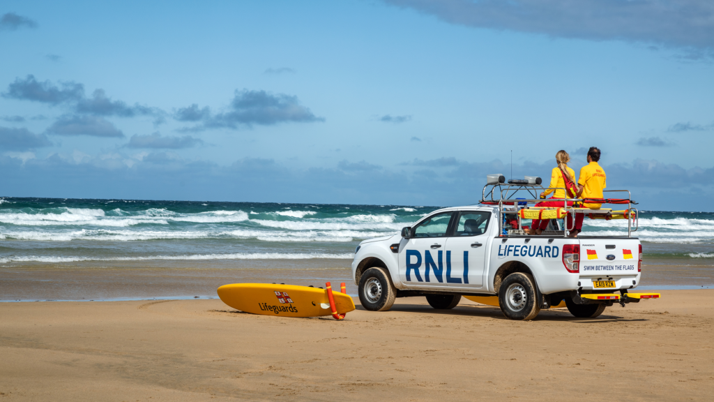 RNLI Lifeguards on a beach safety vehicle