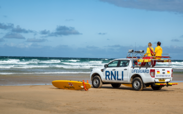 RNLI Lifeguards on a beach safety vehicle